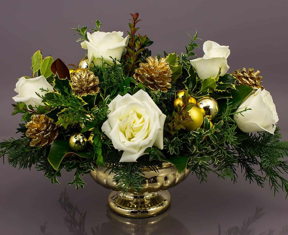 gold container, elegant white roses and beautiful seasonal evergreens