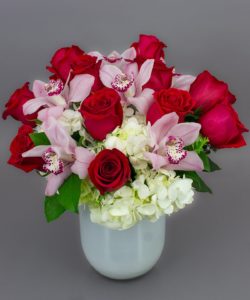 The Lavish Valentine Bouquet truly "says it with flowers". We've included all the favorites, like orchids, roses, and hydrangea in this design. Arranged in our imported Dutch Emilia Vase, this bouquet really hits the mark.
